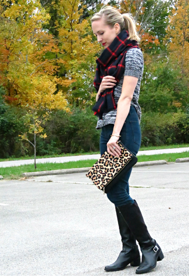 high waist jeans, black riding boots, short sleeve sweater, plaid scarf, leopard clutch