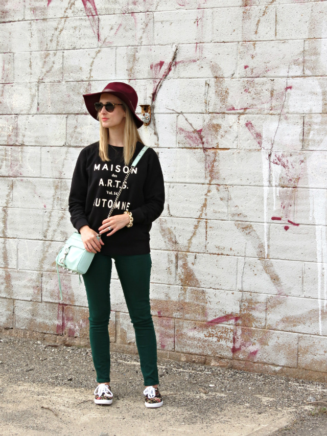 madewell graphic sweatshirt, green jeans, burgundy hat, floral sneakers