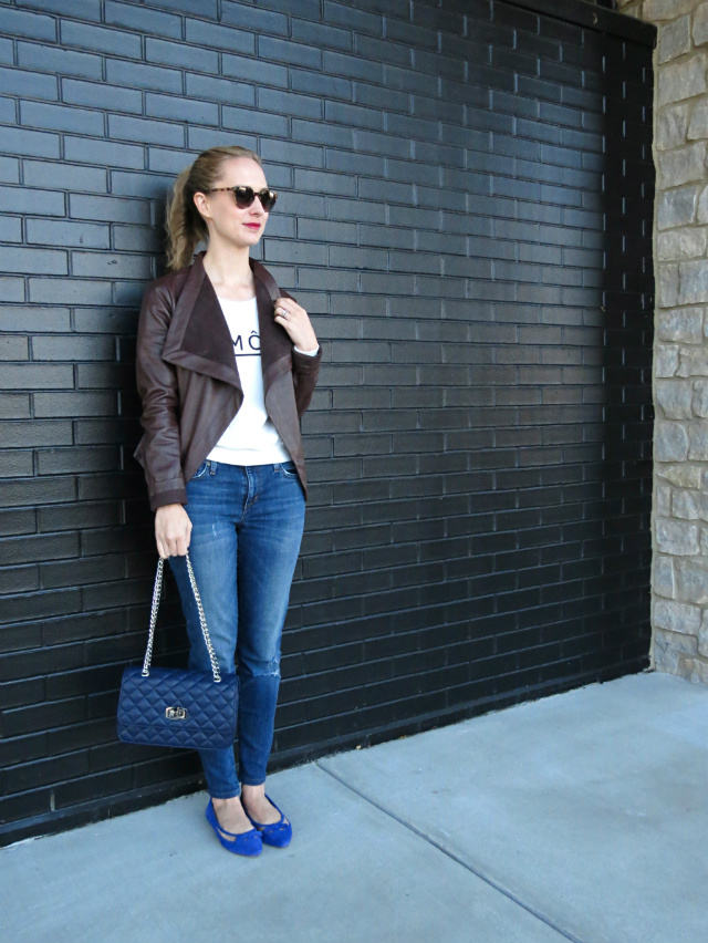 graphic sweatshirt, brown leather jacket, distressed skinny jeans, cobalt suede flats, navy quilted bag