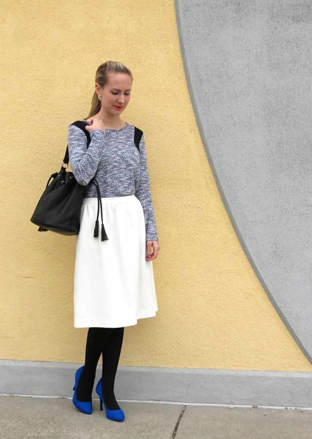white midi skirt, colorblock sweater, black bucket bag, cobalt suede pumps, leopard coat, le tote