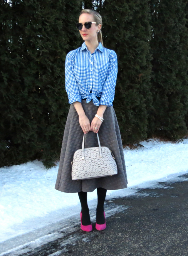 joa quilted midi skirt, knotted gingham shirt, double pearl earrings, pink suede pumps, perforated gray satchel