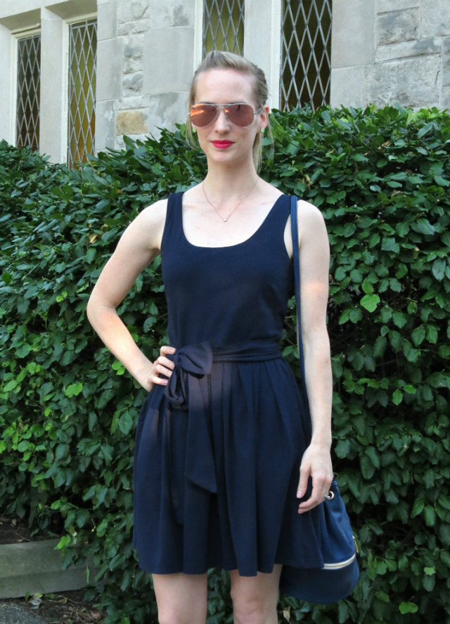 navy fit and flare dress, varsity jacket, bucket bag, striped flats outfit