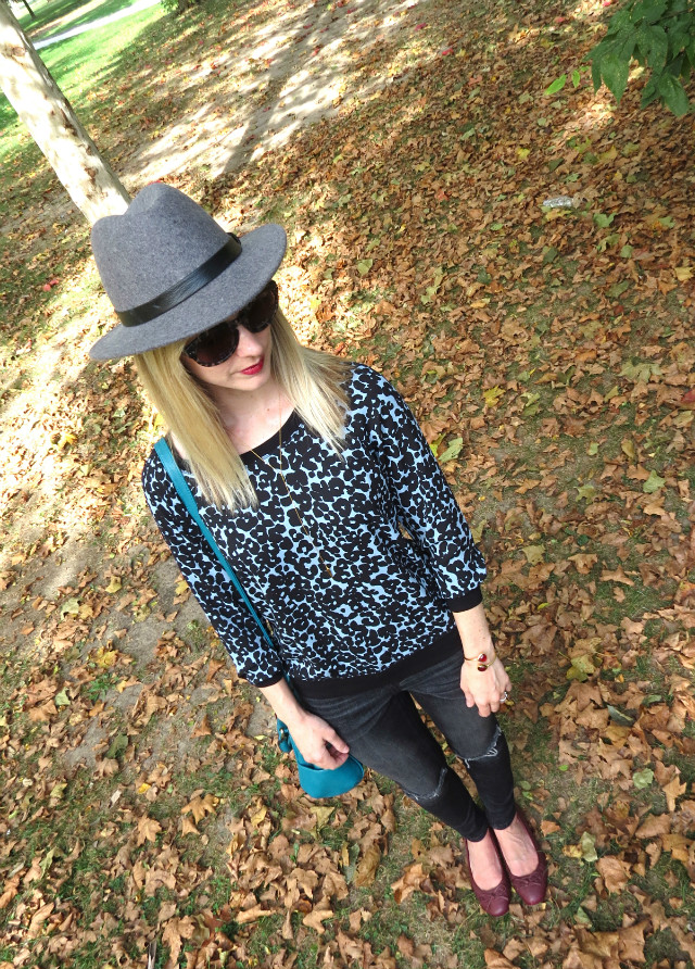 J. Crew wool hat, blue leopard top, black distressed skinny jeans