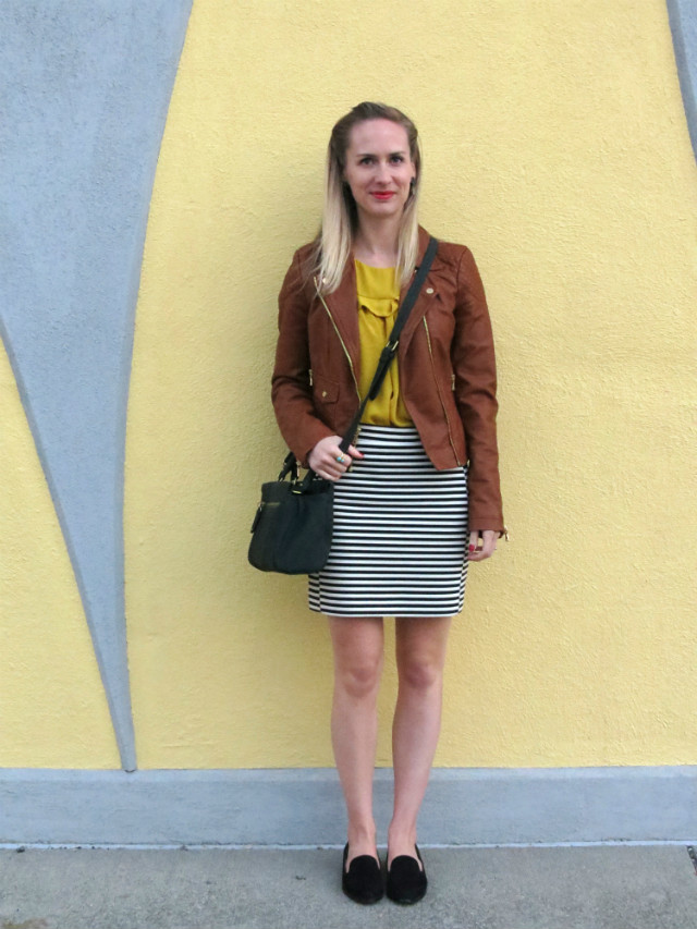 brown faux leather jacket, striped mini skirt, mustard yellow top, black suede loafers