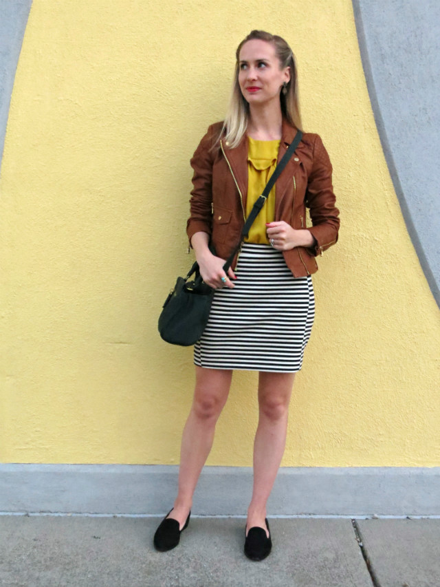 brown faux leather jacket, striped mini skirt, mustard yellow top, black suede loafers