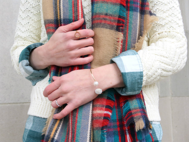 mixing plaids, layering sweater over button up shirt