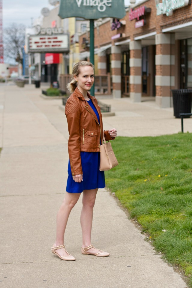 fit and flare dress with tan faux leather moto jacket, studded flats
