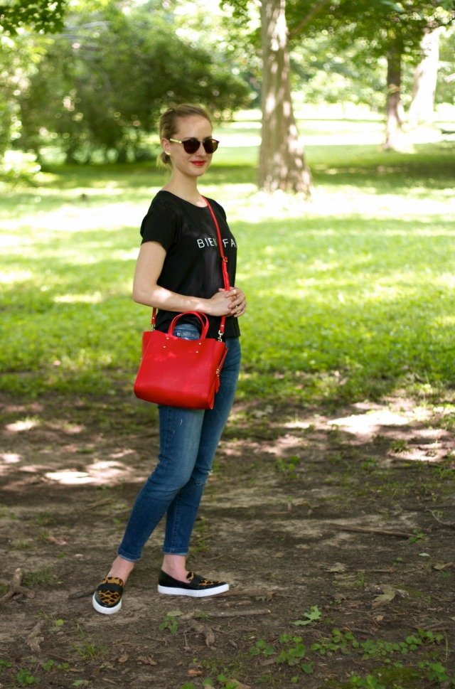 distressed jeans, graphic tee, red satchel, leopard sneakers