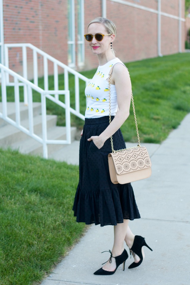 lemon sweater, black midi skirt, fringe pumps, laser cut bag