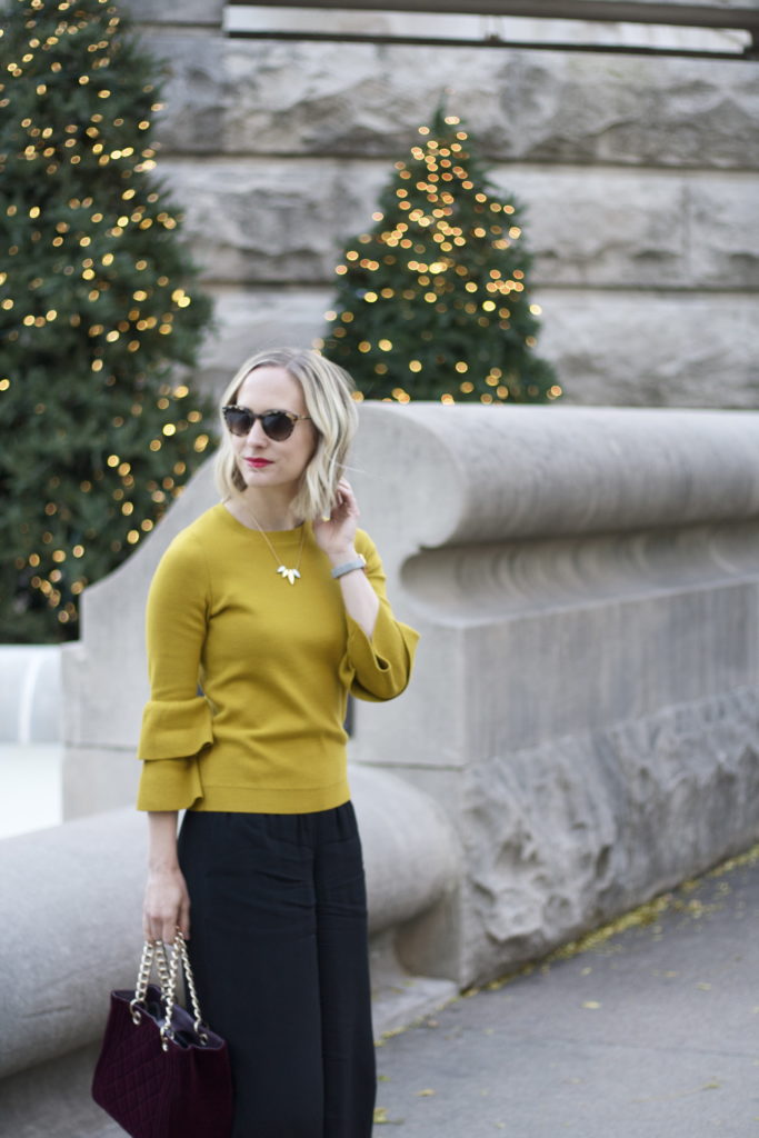 chartreuse bell sleeve sweater, culottes, strappy leopard pumps, velvet bag