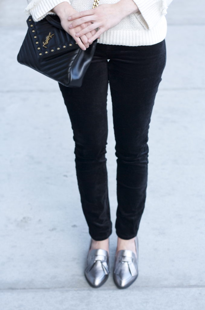 cream fringe sweater, velvet skinny jeans, YSL college bag, metallic loafers